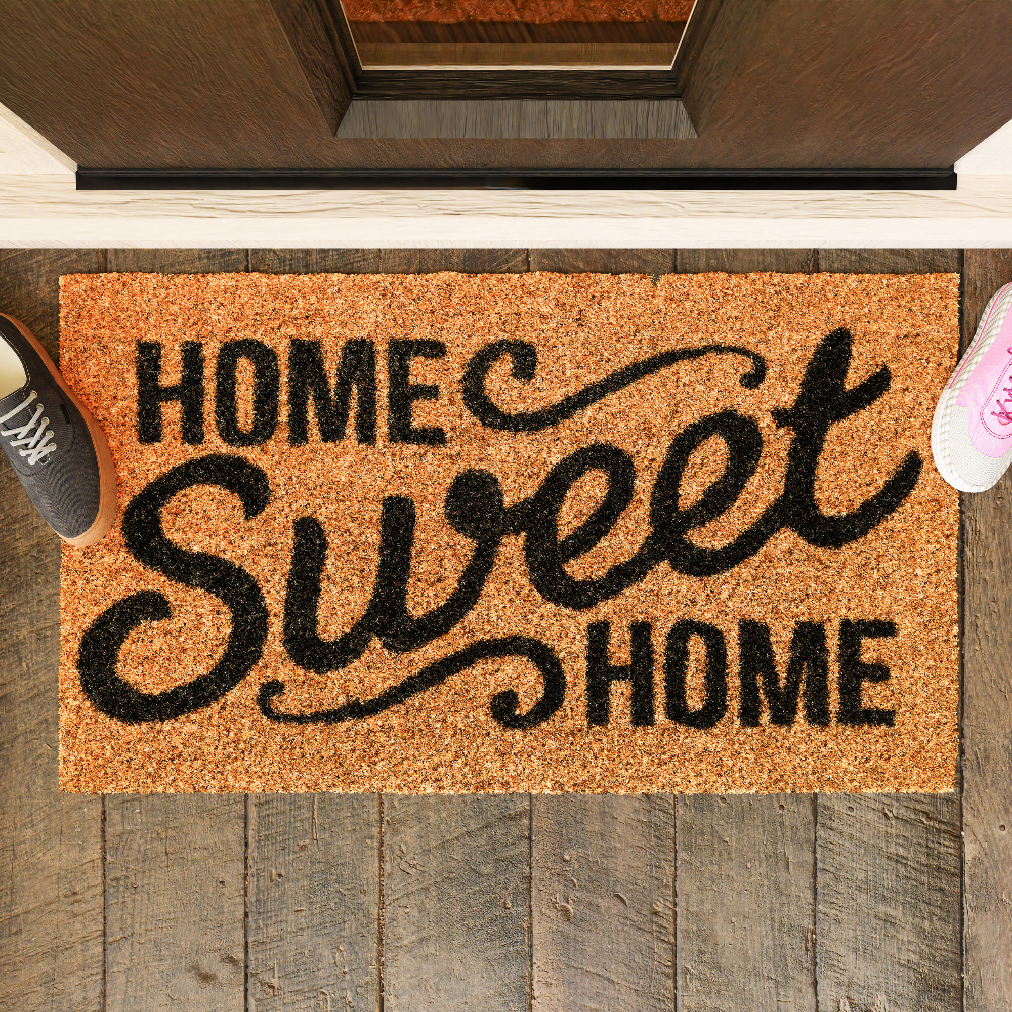 Coir rug in front of door with "Home Sweet Home" painted in black.